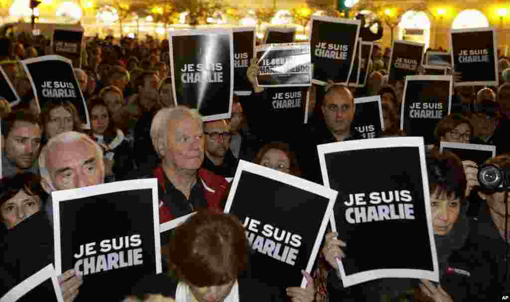 People hold posters reading "I am Charlie" as they gather to express solidarity with those killed in an attack at the Paris offices of the weekly paper Charlie Hebdo, in Nice, southeastern France, Jan. 7, 2015.