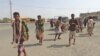 Yemeni fighters loyal to the Saudi-backed Yemeni president walk down a street in the town of Khokha in the western province of Hodeidah on Dec. 18, 2018. 