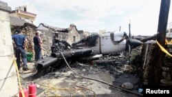 Soldiers clean the wreckage of a TransAsia Airways turboprop plane that crashed on Taiwan's offshore island Penghu on July 25, 2014. 