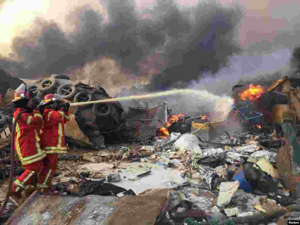 Firefighters spray water at a fire after an explosion was heard in Beirut, Lebanon Aug. 4, 2020.