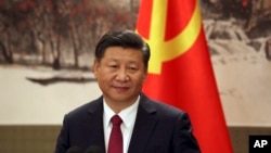 FILE - Chinese President Xi Jinping, one of the seven newly elected members of the Politburo Standing Committee, attends a press event at Beijing's Great Hall of the People on Oct. 25, 2017. 