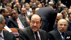 Iraqi Prime Minister Nouri al-Maliki, center, attends the first session of parliament in the heavily fortified Green Zone in Baghdad, Iraq, July 1, 2014. 