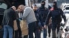 Police look at bags of evidence material during a search in the Brussels borough of Schaerbeek following Tuesday's bombings in Brussels, Belgium, March 25, 2016. 