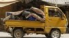 A man waves as he flees Aleppo, July 29, 2012. 
