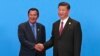 Cambodian Prime Minister Hun Sen, left, and Chinese President Xi Jinping, right, shake hands during the welcome ceremony for the Belt and Road Forum, at the International Conference Center at Yanqi Lake in Beijing, Monday, May 15, 2017. (Roman Pilipey/Pool Photo via AP)

