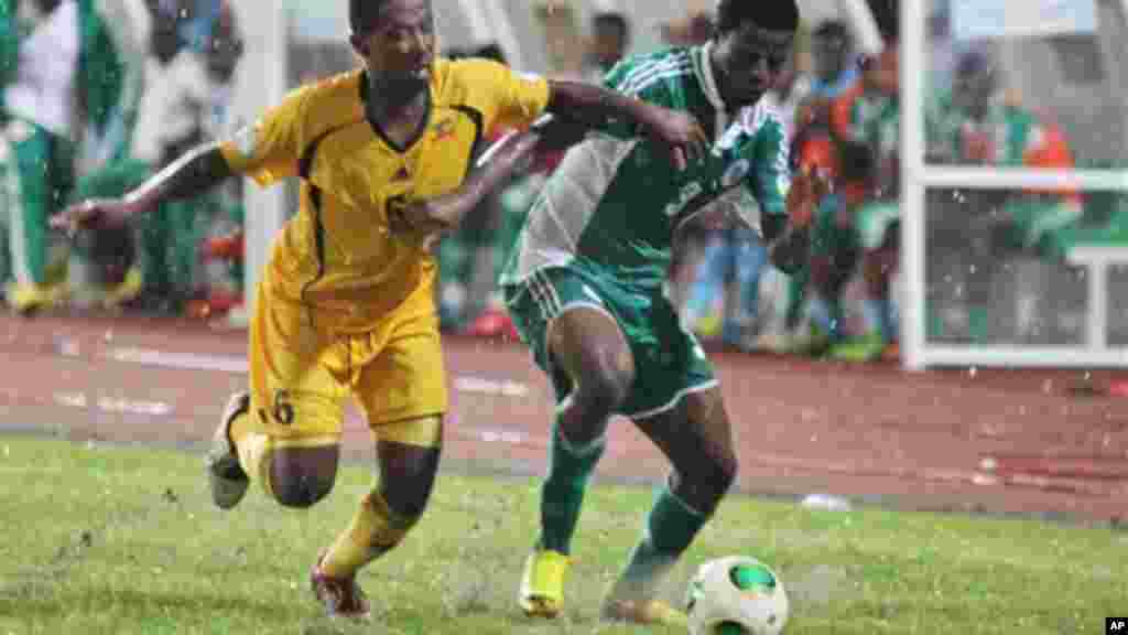 Nigeria's Echiejile Elderson, right, is challenged by Ethiopia's Alula Girma, left, during their 2014 World Cup qualifying playoff match.