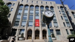 A passer-by skates past an entrance to the Tsai Performance Center on the campus of Boston University.