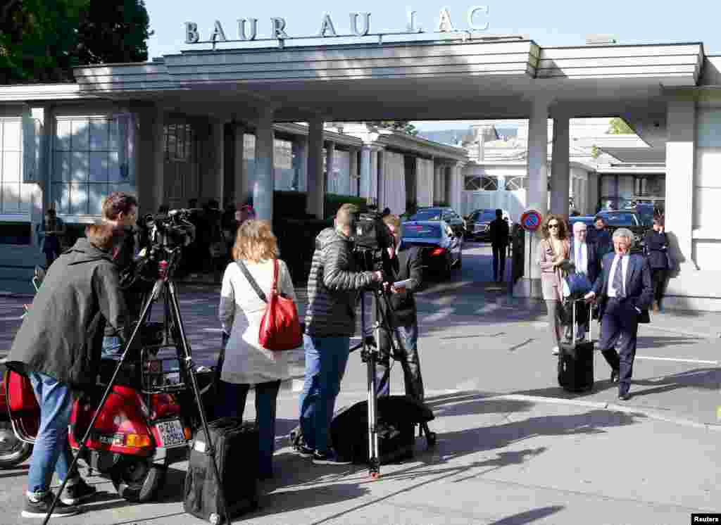 Members of the media stand outside the Baur au Lac hotel in Zurich, Switzerland, May 27, 2015. 