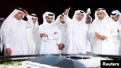 FILE - Qatar Secretary-General Hassan Al-Thawadi (3rd L), of the nation's 2022 World Cup organizing committee, speaks during a news conference in June 2014.
