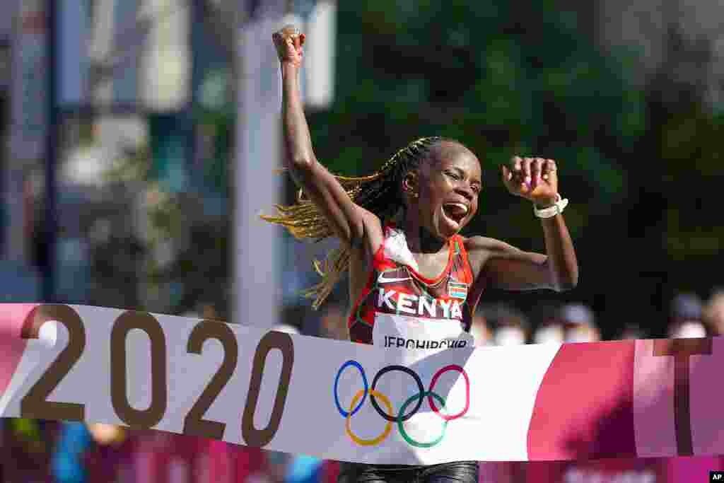 Peres Jepchirchir, of Kenya, celebrates as she crosses the finish line to win the women's marathon at the 2020 Summer Olympics, Saturday, Aug. 7, 2021, in Sapporo, Japan. (AP Photo/Eugene Hoshiko)