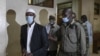 Mohamed Ahmed Abdi, left, and Hassan Hussein Mustafa, center, are escorted away after being sentenced for their involvement in the Westgate Mall attack of Sept. 2013, in Nairobi, on Oct. 30, 2020.