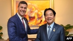 ARCHIVO - El presidente de Paraguay, Santiago Peña, a la izquierda, y el entonces vicepresidente taiwanés, Lai Ching-te, se estrechan la mano durante la visita de Lai a Paraguay, en Asunción el 14 de agosto de 2023.