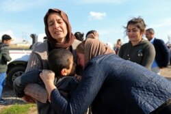 Relatives hug a Yazidi survivor boy following his release from Islamic State militants in Syria, in Duhok, Iraq, March 2, 2019.