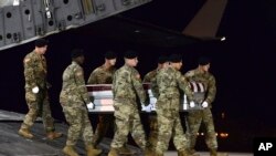 Des soldats américains portent le cercueil contenant les restes du sergent Wright de Lyon, tué avec trois autres de ses camarades dans une embuscade à Tongo Tongo, Niger, à la base aérienne de Dover, Delware, 5 octobre 2017,