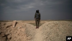 Tentara Pasukan Demokratik Suriah (SDF) berdiri di atas bukit di luar Desa Baghouz, Suriah, 14 Februari 2019. 