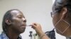FILE - A patient receives treatment at the Arlington Free Clinic in Arlington, Virginia.
