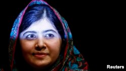 Pakistani schoolgirl Malala Yousafzai, the joint winner of the Nobel Peace Prize, leaves after speaking at Birmingham library in Birmingham, central England, Oct 10, 2014.