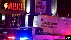 American police investigate a mass shooting at three massage businesses on March 16, 2021, in the Atlanta area of Georgia. Eight people were killed. (AP Photo/Mike Stewart)