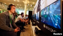 FILE - A gamer plays "Call of Duty: Advanced Warfare" on an Xbox One console during the Xbox Play Day 2014, before the Gamescom 2014 fair in Cologne August 12, 2014. (REUTERS/Wolfgang Rattay)
