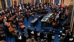 FILE - In this Thursday, Jan. 16, 2020, file image, presiding officer Supreme Court Chief Justice John Roberts swears in members of the Senate for the impeachment trial against President Donald Trump at the U.S. Capitol in Washington.