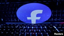 Logo de Facebook frente a teclado de computadora.
