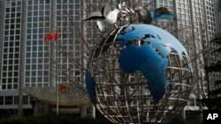 A globe sculpture sits on display outside the Ministry of Foreign Affairs office in Beijing, Wednesday, March 18, 2020. 