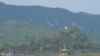 FILE - A North Korean loudspeaker, top left, a military guard post, top right, and a South Korean military guard post, bottom, are seen from Paju, South Korea, near the border with North Korea, Oct. 10, 2024. 