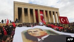 Odamlar Mustafo Kamol Otaturk portreti bilan. Anqara, 10-noyabr 2015-yil 