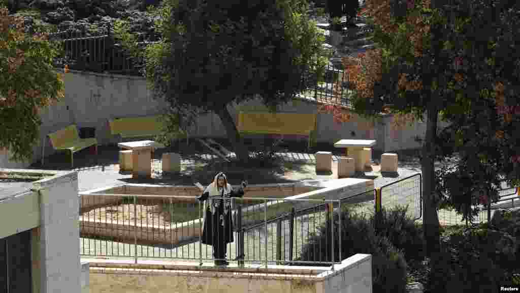 An ultra-Orthodox Jew prays near the scene of an attack at a Jerusalem synagogue, Nov.18, 2014.