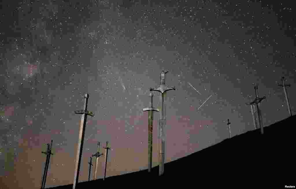 Comet C/2023 A3 (Tsuchinshan-ATLAS), meteors and satellite trails are seen in the night sky above the Battle of Didgori memorial complex in Didgori, Georgia, Oct. 30, 2024.