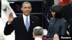 U.S. President Barack Obama is sworn in by Supreme Court Chief of Justice John Roberts, as first lady Michelle Obama looks on during inauguration ceremonies in Washington, D.E., January 21, 2013.