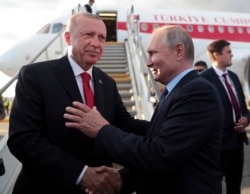 FILE - Russia's President Vladimir Putin, right, shakes hands with Turkey's President Recep Tayyip Erdogan, outside Moscow, Aug. 27, 2019.