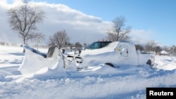 A snow plow is left stranded on the road following a winter storm that hit the Buffalo region on Main St. in Amherst, New York, Dec. 25, 2022.