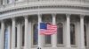 A U.S. flag is raised at the U.S. Capitol in Washington, Jan. 20, 2021.