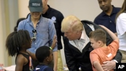 President Donald Trump and Melania Trump meet people affected by Hurricane Harvey during a visit to the NRG Center in Houston, Texas, Sept. 2, 2017.