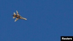 Sebuah jet tempur terbang di atas Suriah dekat perbatasan Suriah Israel seperti yang terlihat dari Dataran Tinggi Golan yang diduduki Israel, 23 Juli 2018.