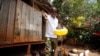 Bernard Mwololo feeds chickens at the Nyumbani Children's Home in Nairobi, Kenya, on Aug. 15, 2023. Benard, who has lived most of his life at the orphanage after his parents died of AIDS, believes he is alive only because of antiretroviral drugs made possible by U.S. assistance.