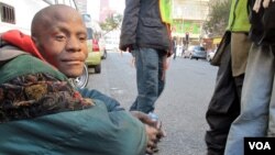 Buhlebezwe Mlambo is mentally ill and homeless. His friend Sello looks after him on the street, June 13, 2013 (G. Parker/VOA).