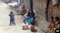 Myanmar Muslims, who identify themselves as long-persecuted “Rohingya” Muslims, sit on the ground at Da Paing camp for Muslim refugees in north of Sittwe, Rakhine State, western Myanmar, April 2, 2014.