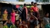 Rohingya Muslims, who crossed over from Myanmar into Bangladesh, wait to collect aid at Kutupalong refugee camp in Ukhiya, Bangladesh, Dec. 21, 2017. 