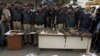 Police officers display confiscated ammunition and the dead bodies of terrorists who attacked the Jinnah International Airport Monday in Karachi, Pakistan, June 9, 2014. 