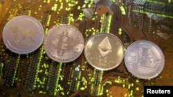FILE - Representations of the Ripple, Bitcoin, Etherum and Litecoin virtual currencies, Feb. 13, 2018. 