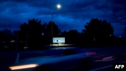 A car passes by Facebook's corporate headquarters location in Menlo Park, California, on March 21, 2018.