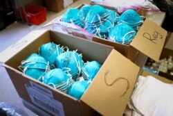 FILE PHOTO: Boxes of N95 protective masks for use by medical field personnel are seen at a New York State emergency operations incident command center during the coronavirus outbreak in New Rochelle, New York, U.S., March 17, 2020. REUTERS/Mike…