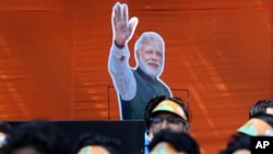 FILE - India’s Bharatiya Janata Party workers listen to Prime Minister Narendra Modi addressing them via video conference in New Delhi, India, Feb.28, 2019.