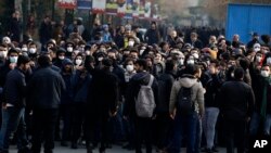 Anti-government protesters attend a demonstration blaming the government for the delayed announcement of the unintentional downing of a Ukrainian plane last week, at the Tehran University campus in Tehran, Iran, Tuesday, Jan. 14, 2020.