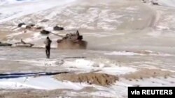 FILE - A screenshot from video shows the disengagement process between the Indian Army and China's People's Liberation Army from a contested lake area in the western Himalayas, in Ladakh region, India, Feb. 11, 2021. (Indian Army/Reuters TV/via Reuters)