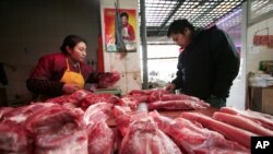 在上海，一位顾客在肉铺挑肉(资料照片)