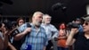 FILE - Dmitry Muratov, foreground, chief editor of Novaya Gazeta, and the Ekho Moskvy (Echo of Moscow) radio station's editor-in-chief, Alexei Venediktov, speak in Moscow, Russia, in June 2019.