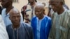 Ousainou Darboe, the head of the United Democratic Party (C), arrives with 18 others for a hearing at Gambia's supreme court in Banjul, Dec. 5, 2016. They had been arrested in April after they took part in a peaceful demonstration and sentenced to three years in prison.